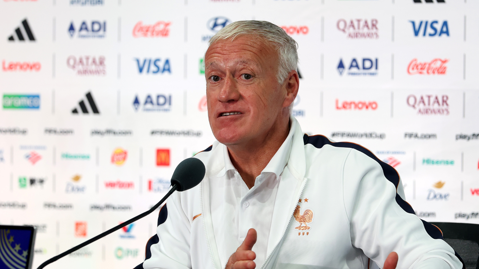 Didier Deschamps intently observing a training session or match, reflecting on strategy for the FIFA World Cup.
